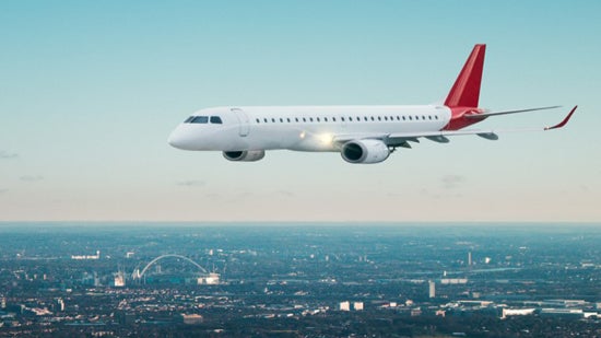 Private jet flying over city