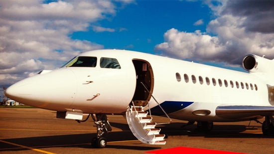 Airplane with red carpet leading up to it